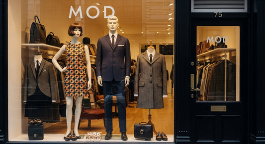 Mod clothes shop in London featuring tailored suits, shift dresses, and scooters parked outside a boutique.
